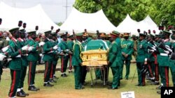 Military pallbearers carry the coffin of Nigeria's army chief, Lt. Gen. Ibrahim Attahiru, who was killed along with 10 others in plane crash on Friday, during a funeral at the military cemetery in Abuja, Nigeria, May 22, 2021.