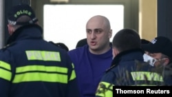 Georgian police storm opposition party offices, detain its leader Nika Melia who has been accused of inciting violence at street protests in June 2019, a charge he dismisses as politically motivated. 