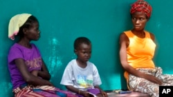 A Pakistani migrant stranded on the Greek island of Lesbos sits behind a cross near the port of Mytilini. Pope Francis will visit the island Saturday joined by Ecumenical Patriarch Bartholomew and the head of the Orthodox Church of Greece, Athens Archbishop Ieronymos II.