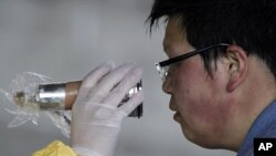 A man who was evacuated from the vicinity of Fukushima's nuclear power plants is screened for radiation levels at a makeshift facility in Nihonmatsu, northern Japan, March 14, 2011