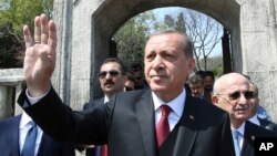 Turkey's President Recep Tayyip Erdogan waves after he visited the graves of three conservative late Turkish prime ministers, in Istanbul, April 17, 2017.