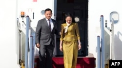 柬埔寨首相洪马内(左)抵达北京首都国际机场，出席2023年10月16日在北京举行的第三届“一带一路”高峰论坛。（法新社照片）