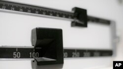 FILE - An April 3, 2018, illustration photo shows a closeup of a beam scale in New York.