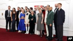 FILE - Cast members pose upon arrival at the premiere for 'The Crown' season 6 finale, in London on Dec. 5, 2023. Even when hit TV series such as "The Crown" or "Bridgerton" have wide appeal, Netflix still tries to cater to the divergent tastes in its vast audience.
