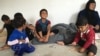 Iraqi refugee children who fled IS with their families playing on the concrete floor of their new home in a camp outside Makhmour, Iraq, April 11, 2016. (S. Behn/VOA)