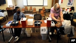 Officials say, the vaccine campaign in Tuskegee, Alabama is off to a slow start. Here nurse Marianne Williams gives a COVID-19 vaccine to a woman at the county health department in Tuskegee, Alabama on January 25, 2021. (AP Photo)