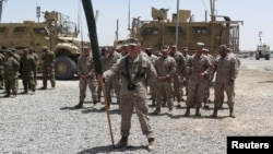 U.S. Marines stand at attention during a transfer of authority ceremony at Shorab camp, in Helmand province, Afghanistan, April 29, 2017. 