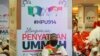 A man sits in front of banners of UMNO (United Malays National Organisation) and PAS (Pan-Malaysian Islamic Party) during an event of officially join alliance in Kuala Lumpur, Malaysia, Saturday, Sept. 14, 2019. Two major opposition parties in…