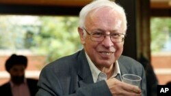 Sweden's Tomas Lindahl, one of the joint winners of the 2015 Nobel Prize for Chemistry, has a drink of champagne at the Francis Crick Institute in Potters Bar, north London, England, Wednesday, Oct. 7, 2015. Sweden's Tomas Lindahl, American Paul Modrich and U.S.-Turkish scientist Aziz Sancar won the Nobel Prize in chemistry on Wednesday for "mechanistic studies of DNA repair. (AP Photo/Alastair Grant)