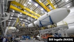 The Falcon 9 rocket and DART spacecraft readied for launch are seen at the SpaceX hanger, Vandenberg Space Force Base in California, Nov. 22, 2021. 