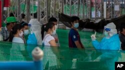 រូប​ឯកសារ៖ បុគ្គលិកសុខាភិបាលថៃកំពុងធ្វើតេស្តរកជំងឺកូវីដ១៩ លើពលករចំណាកស្រុកនិងក្រុមគ្រួសាររបស់ពួកគេ នៅកន្លែងធ្វើតេស្តមួយក្នុងខេត្ត Samut Sakhon ភាគខាងត្បូងទីក្រុងបាងកក ប្រទេសថៃ កាលពីថ្ងៃទី៤ ខែមករា ឆ្នាំ២០២១។