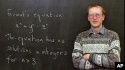 FILE - Princeton University mathematics professor Andrew John Wiles poses next to "Fermat's Last Theorem" written on a chalkboard in his Princeton, N.J., office Tuesday, Jan. 6, 1998. 