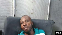 FILE - Arnel Joseph dressed and on a stretcher as a UN helicopter prepares to transfer him to Port au Prince, Haiti, in 2019.