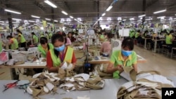 In this Oct. 24, 2017, photo, garment workers sew clothes at Pro Sports factory in Nam Dinh province, Vietnam. U.S. President Donald Trump's decision to withdraw from a far-reaching Pacific Rim trade pact is having scant impact on fast-growing trade…