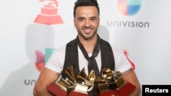 Luis Fonsi holds his awards for Song of the Year, Record of the Year and Best Long Form Music Video for "Despacito" and Best Urban Fusion/Performance for "Despacito (Remix)." 