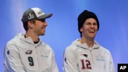 Philadelphia Eagles' Nick Foles and New England Patriots' Tom Brady answer questions during NFL football Super Bowl 52 Opening Night Monday, Jan. 29, 2018, at the Xcel Center in St. Paul, Minn. (AP Photo/Eric Gay)