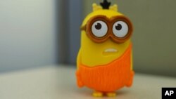 This Friday, July 10, 2015 photo shows a "Minion" toy in New York, distributed in McDonald's restaurant's Happy Meals. The company says the talking toy is speaking only nonsense words and not something a little more adult. Experts say McDonald's may be right, and the fault may lie in how our brains are primed to find words even when they're not really there. (AP Photo/Patrick Sison)