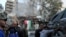 People gather near a damaged site, hauling a destroyed vehicle away, after what Syrian and Iranian media described as an Israeli air strike on Iran's consulate in the Syrian capital Damascus April 1, 2024.