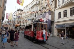 A poster of Binali Yildirim, mayoral candidate of the Justice and Development Party, hangs on a building on the city's landmark Istiklal Street, in Istanbul, June 21, 2019, ahead of June 23's rerun of Istanbul elections.