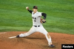Japan pitcher Shohei Ohtani delivers a pitch during the ninth inning against the USA at LoanDepot Park in Miami on Mar. 21, 2023. (Sam Navarro-USA TODAY Sports)