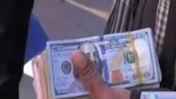 گزارش تصویری در مورد افت بهای افغانی در مقابل اسعار خارجی