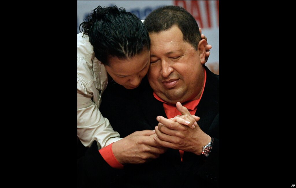 Chavez shares a moment with his daughter Rosa as he attends a concert in his honor at the Teresa Carreno theater in Caracas, February 23, 2012.