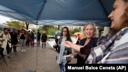 FILE - Sen. Kirsten Gillibrand, D-N.Y., second from right, joins survivors of sexual assault Faith Ferber, third from right and Sage Carson, right, at a rally outside the Department of Education on Sept. 6, 2017. (AP Photo/Manuel Balce Ceneta)