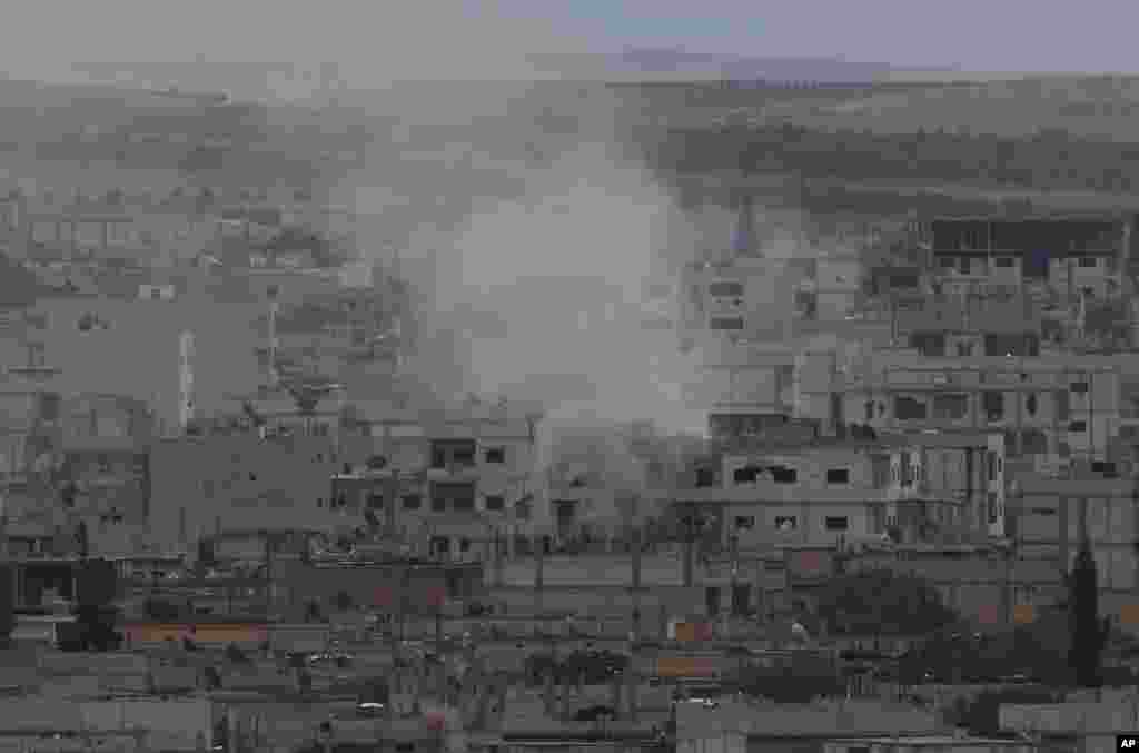 Smoke from a fire rises in Kobani, Syria while fighting continues between Syrian Kurds and the&nbsp; Islamic State militants, near the Turkey-Syria border, Oct. 16, 2014. 