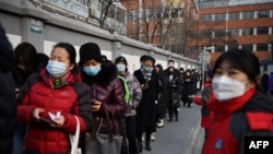 People line up to be tested for COVID-19 during a drive to test two million people in 48 hours, in Beijing.