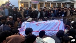 FILE - Pakistanis attend a funeral service for the victims of a bomb blast at a mosque in Parachinar, the capital of Pakistan's northwestern Kurram tribal region, Jan. 21, 2017. 