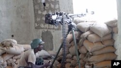 A soldier in the African Union Mission in Somalia takes his position during fighting between Islamists and government forces, in southern Mogadishu, February 14, 2012.