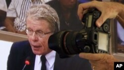 Photographer take pictures of David Chandler, 76, a researcher and author who writes book about Khmer Rouge history, is seen in a screen at the court press center of the U.N.-backed tribunal, file photo. 