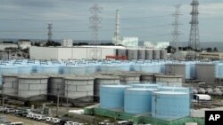 In this Oct. 12, 2017, photo, ever-growing amount of contaminated, treated but still slightly radioactive, water at the wrecked Fukushima Dai-ichi nuclear plant is stored in about 900 huge tanks, including those seen in this photo taken during a plant tour at Fukushima Daiichi Nu