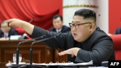 This picture taken during the period of December 28 to December 31, 2019 and released from North Korea's official Korean Central News Agency (KCNA) on January 1, 2020 shows North Korean leader Kim Jong Un attending a session of the 5th Plenary…