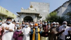 Indian Muslims wear masks and pray for the prevention of coronavirus during a special prayer after Friday prayers at a mosque in Ahmadabad, India, Jan. 31, 2020. 
