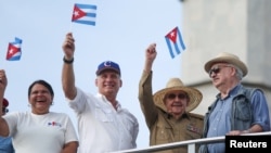 Cuba's First Secretary of the Communist Party and former President Raul Castro, 2nd right, Cuba's President Miguel Diaz-Canel, 2nd left, First Secretary of the Communist Party in Havana Lazara Mercedes Lopez, left, and president of the Communist Party of Chile Guillermo Teillier watch the May Day rally in Havana, Cuba, May 1, 2018.