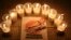 FILE - Lit candles are placed by activists around a placard during a vigil in solidarity with the detainees in Syrian prisons at Aleppo's Salaheddine neighborhood, Jan. 26, 2015. 