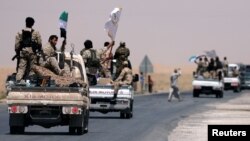 Syrian Democratic Forces (SDF) fighters head to Raqqa, Syria, June 6, 2017. 