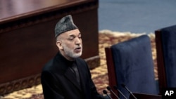 FILE - Afghan President Hamid Karzai speaks during the first day of the Loya Jirga in Kabul, Afghanistan, Nov. 21, 2013.