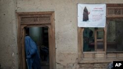 A woman leaves a Shiite shrine in a predominantly Hazara neighborhood in Kabul, Nov. 9, 2021. 