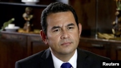 FILE - Then-presidential candidate Jimmy Morales speaks with a Reuters reporter in Guatemala City, Aug. 20, 2015. 