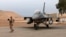 FILE - An Iraqi soldier stands guard near a U.S.-made Iraqi air force F-16 jet at Balad Air Base, north of Baghdad, Iraq, Feb. 13, 2018. 