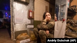 A Ukrainian soldier take a rest near a fighting position on the line of separation from Russian-led forces near Katerinivka, December 7, 2021. (Andriy Dubchak/AP)