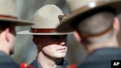 FILE - Members of the Rhode Island State Police attend a ceremony at the State House in Providence, Rhode Island, Jan. 1, 2019.