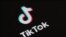 (FILES) This illustration picture taken on May 27, 2020 in Paris shows the logo of the social network application Tik Tok on the screen of a phone.