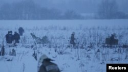 Emergency services work at the scene where a short-haul regional Antonov AN-148 plane crashed after taking off from Moscow's Domodedovo airport, outside Moscow, Feb. 11, 2018.