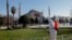 FILE - A worker in a protective suit disinfects Sultanahmet square, with Hagia Sophia in the background, in response to the spread of coronavirus disease (COVID-19) in Istanbul,Turkey, March 21, 2020.