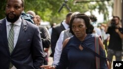 Ahmaud Arbery's mother, Wanda Cooper-Jones, and family attorney S. Lee Merritt leave the Glynn County Courthouse after the preliminary hearing of Travis McMichael, Gregory McMichael and William Bryan, June 4, 2020, in Brunswick, Ga