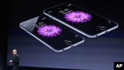 FILE - In this March 9, 2015, file photo, Apple CEO Tim Cook talks about the iPhone 6 and iPhone 6 Plus during an Apple event in San Francisco. Apple is apologizing for secretly slowing down older iPhones, which it says was necessary to avoid unexpected s