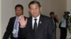 Prime Minister Hun Sen gestures as he arrives at the National Assembly for a meeting in central Phnom Penh, Sept. 24, 2013.